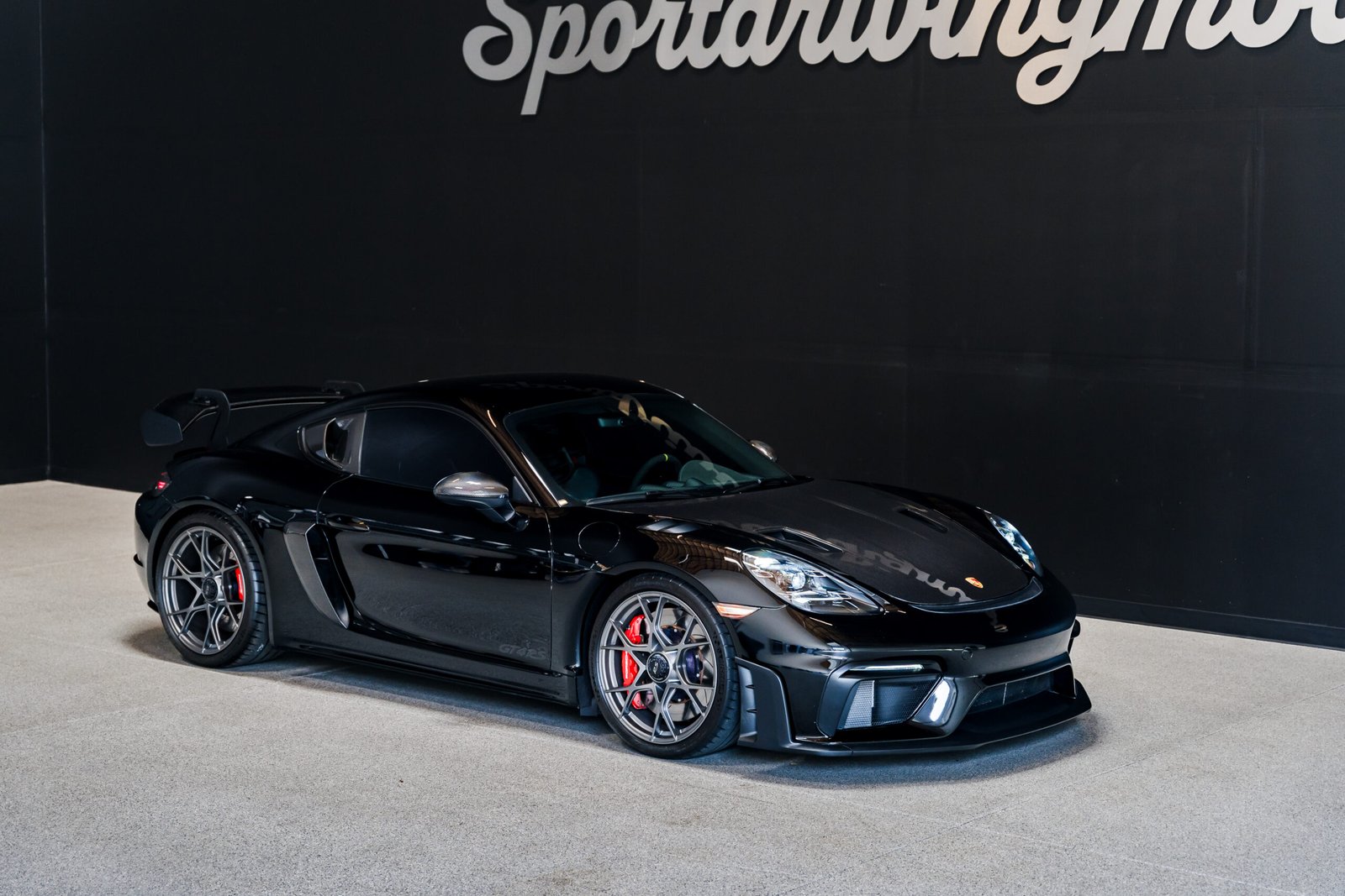 Black Porsche 718 Cayman GT4 RS rental in Seattle from Sport Driving Motors