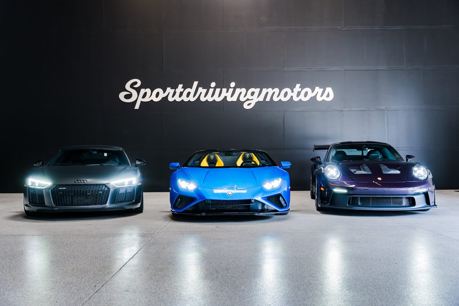 Audi R8, Lamborghini Huracán and Porsche 911 in the Sport Driving Motors showroom in Kent, Washington