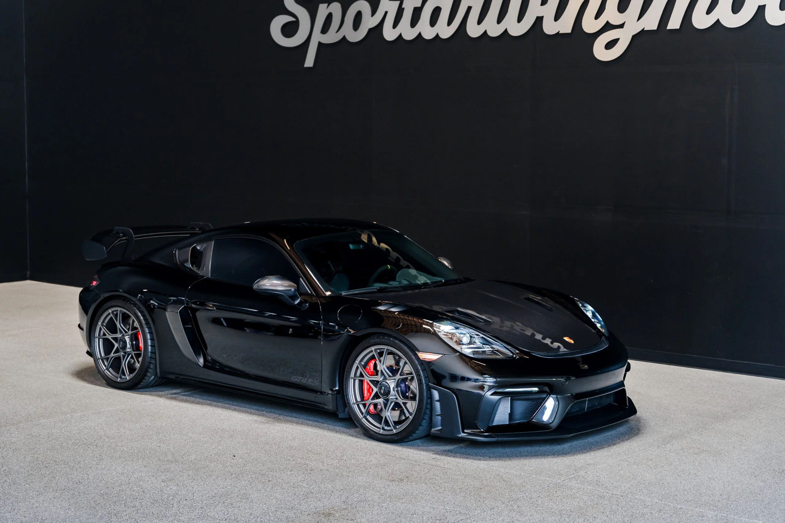 Black Porsche 718 Cayman GT4 RS rental in Seattle from Sport Driving Motors