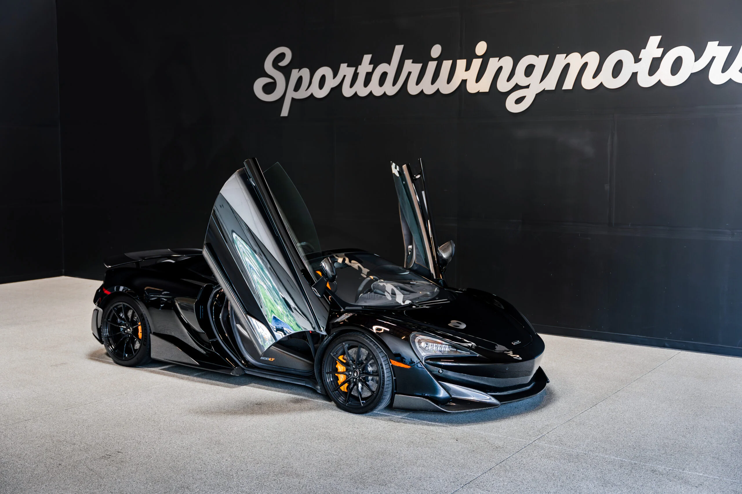 McLaren 600LT Spider rental in Seattle with the dihedral doors open